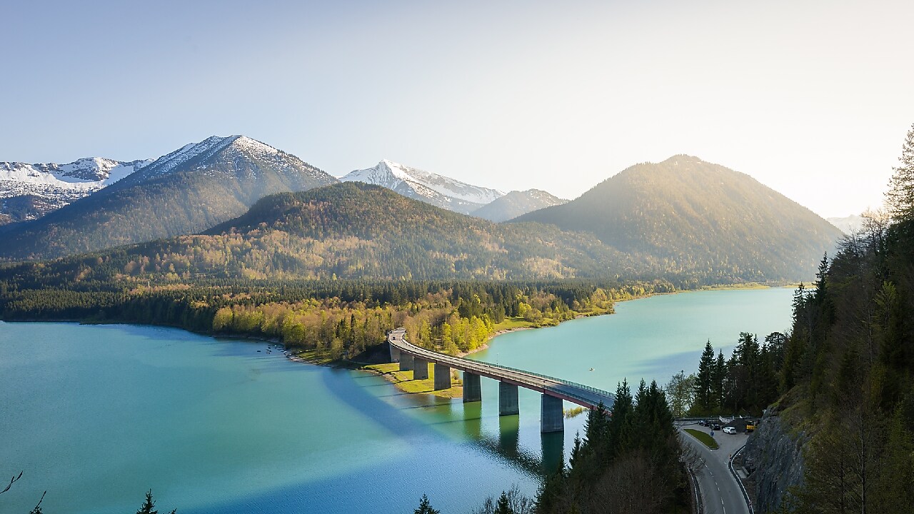 Birds eye view of river with a bridge with “Destination: Carbon Compensation” pointer