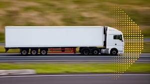 Heavy duty freight truck on a highway at sunrise