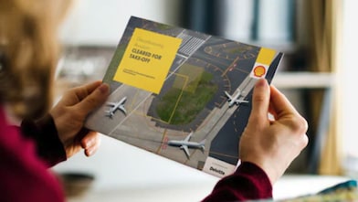Person holding a brochure cover