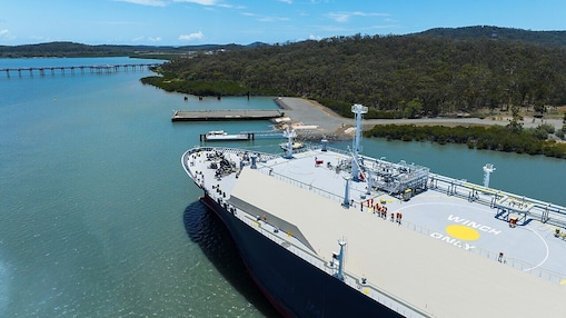 View of the top deck of a ship approaching a harbour.