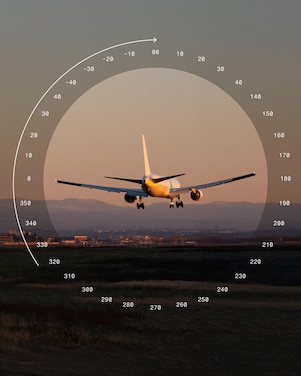 Passenger aircraft approaching a runway, with a mountain and airport infrastructure in the background.