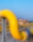 Large interconnected yellow pipes with a blue sky backdrop