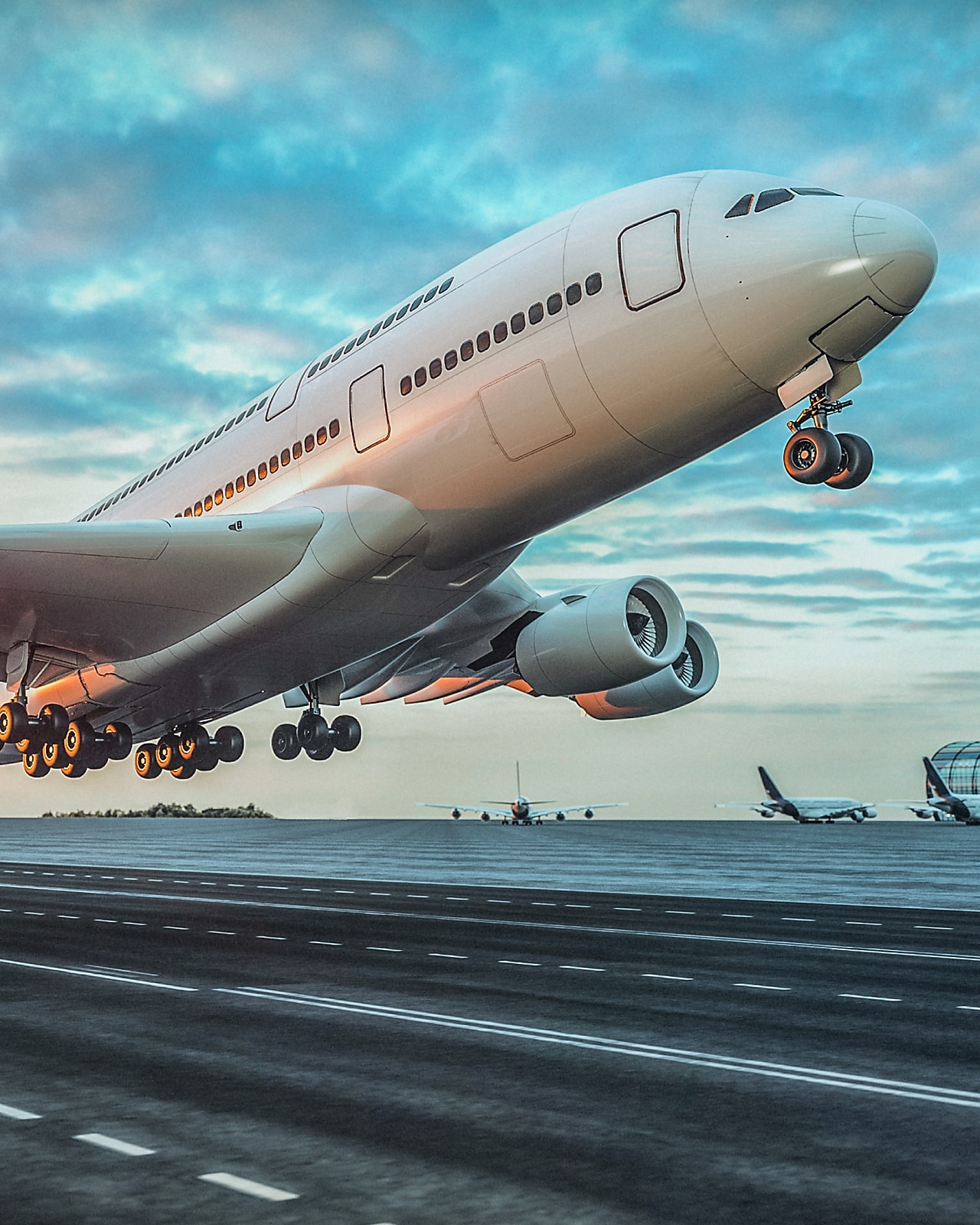 A large commercial airplane taking off from a runway at sunset, with landing gear still extended and the sky filled with colorful clouds.