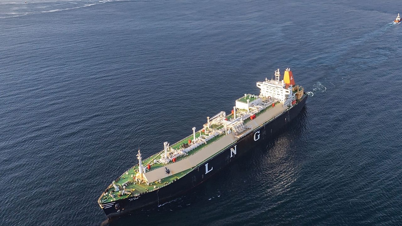 Aerial view of an LNG (liquefied natural gas) tanker sailing on open water, with “LNG” marked prominently on the ship’s side.