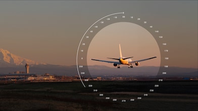 Passenger aircraft approaching a runway, with a mountain and airport infrastructure in the background.