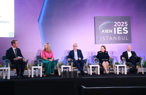 Ross Brown seated with other speakers on stage during a panel session at AIEN IES Istanbul 2025.