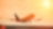 Commercial aeroplane lifting off the runway at sunset, with an orange glow reflecting off the fuselage and sky.
