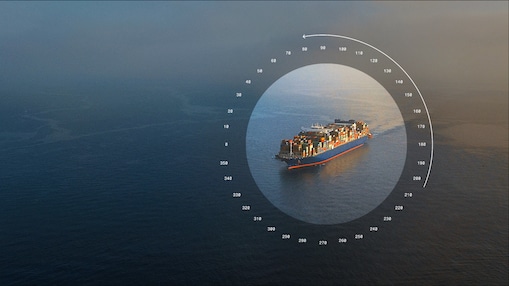 Aerial view of a container ship at sea, highlighted by a circular navigation graphic.