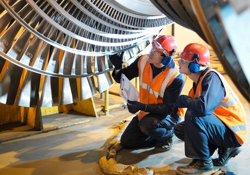 Workers inspect turbine in power station