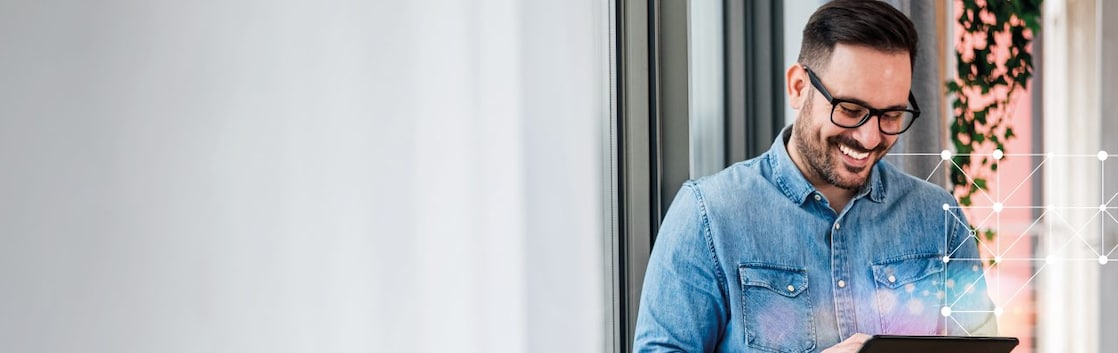man smiling and working on tablet