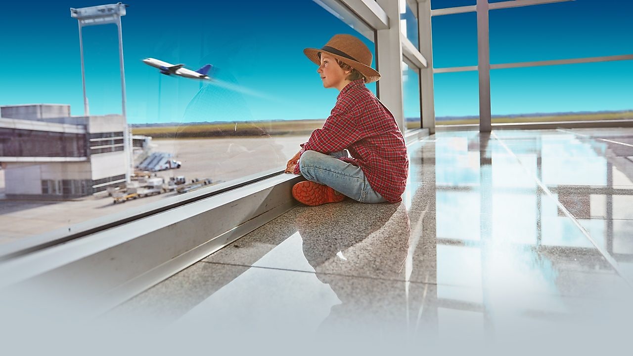 Boy sitting at airport