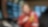 Female technician in red PPE with Shell logo on it, working in front of multiple screens