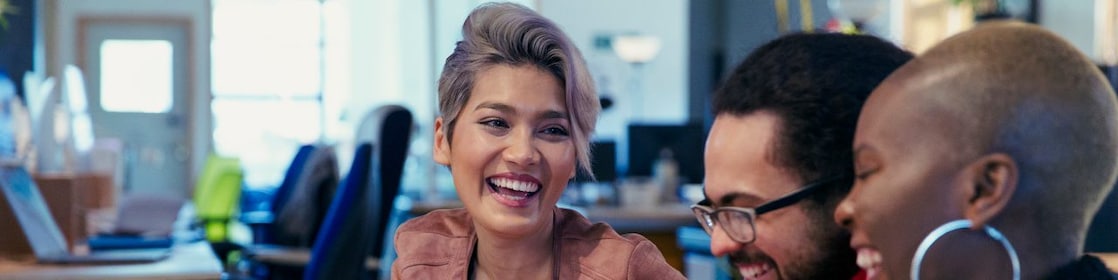 Laughing creative business people working in office