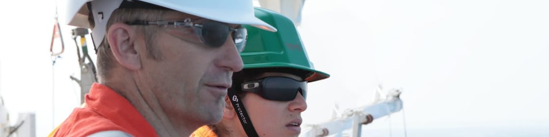 man and woman watching from ship