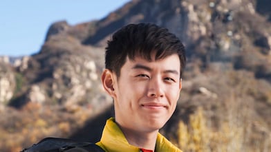 man with binoculars in rural landscape