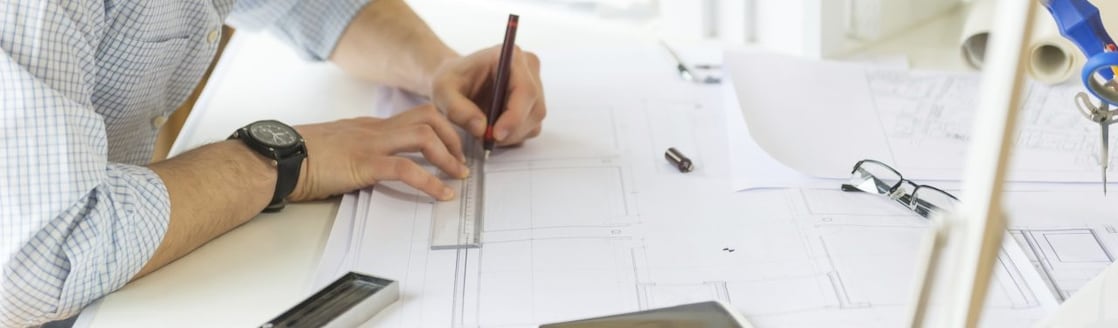 young architect drawing something on paper