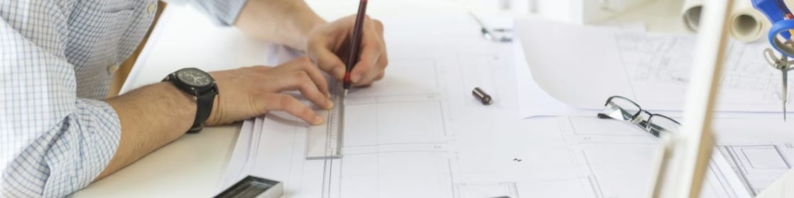 young architect drawing something on paper