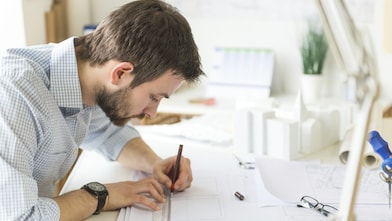 young architect drawing something on paper