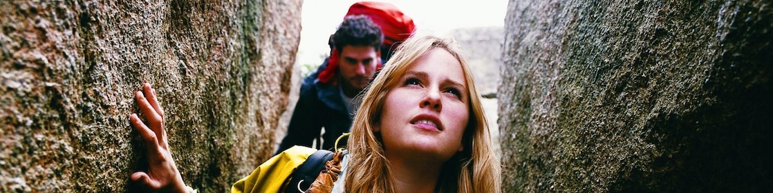 Two People Orienteering Between Rocks