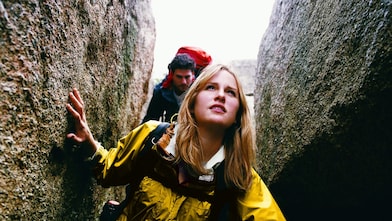 Two People Orienteering Between Rocks