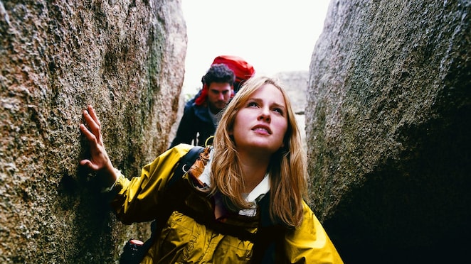 Two People Orienteering Between Rocks