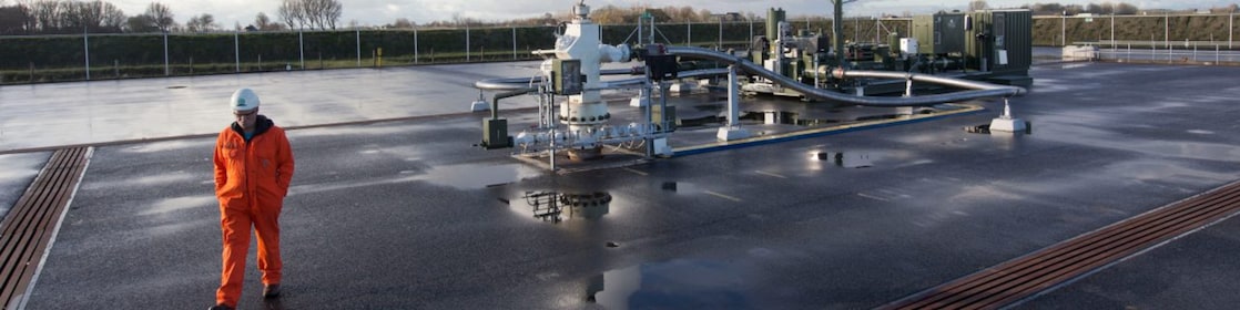 man walking beside a mechanical unit