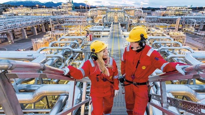 Two shell employees talking at work site