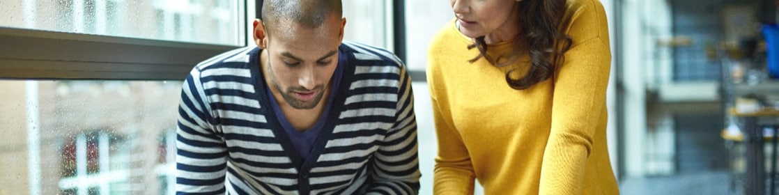 Two architects discussing project at high table