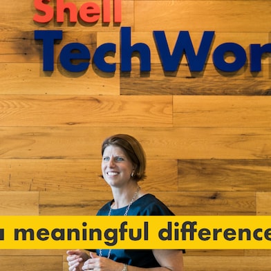 Reason number one – making a meaningful difference. Julie Ferland in front of a Shell TechWorks sign.