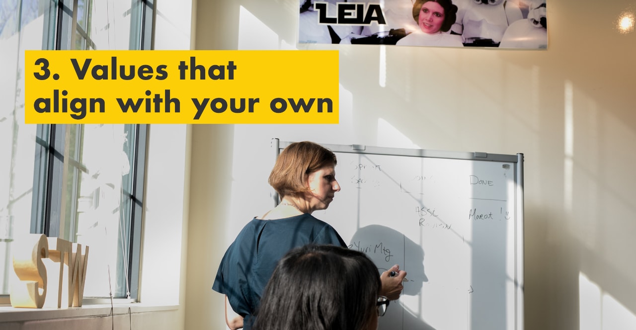 Reason number three – values that align with your own. Julie Ferland writing on a whiteboard.