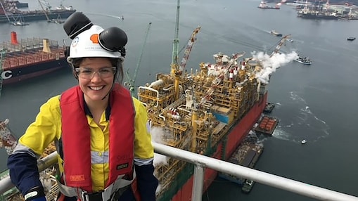 Smiling woman wearing yellow PPE clothing