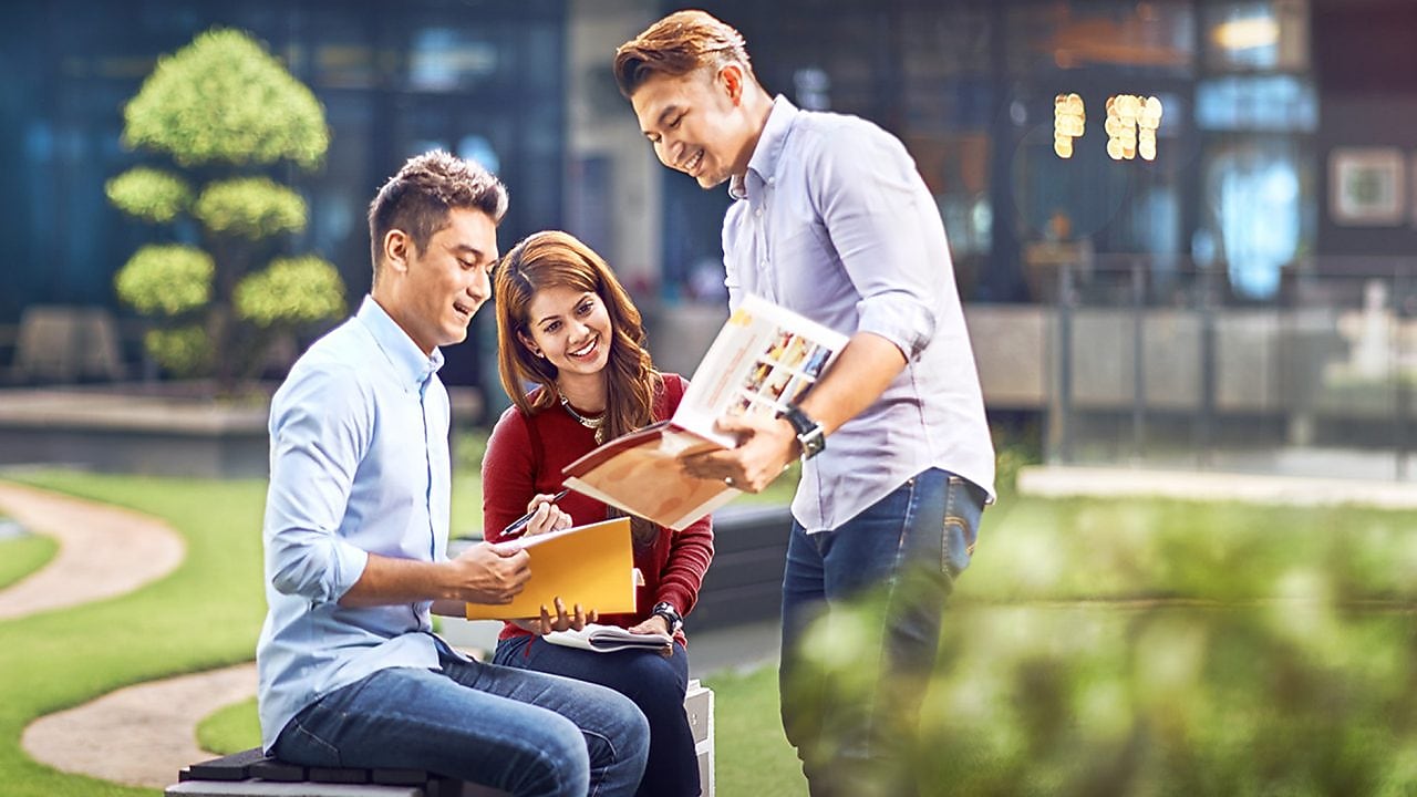two colleagues discussing about a file