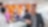 Jason leaning on a cabinet with team members out of focus behind him