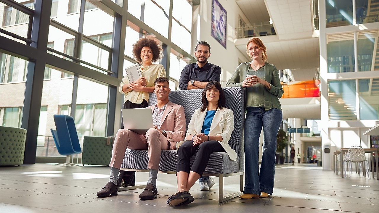 Shell Interns collaborating in a modern, open office environment, showcasing teamwork and innovation as part of the Shell Assessed Internship Programme