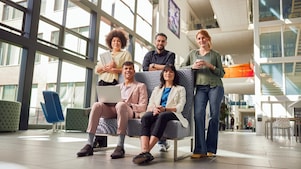 Shell Interns collaborating in a modern, open office environment, showcasing teamwork and innovation as part of the Shell Assessed Internship Programme