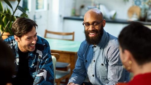 group of people talking and laughing in an office
