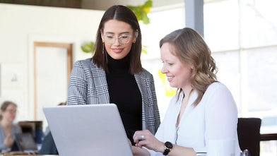 Female teacher in one-to-one tutorial with female student