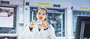 A women in protective glasses working in a lab