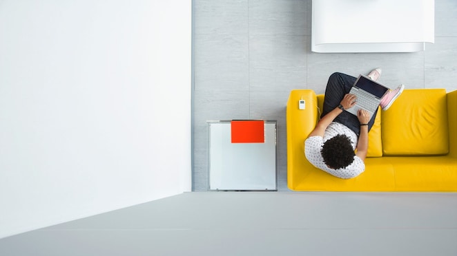 top-view-lady-on-ipad-sitting-on-sofa