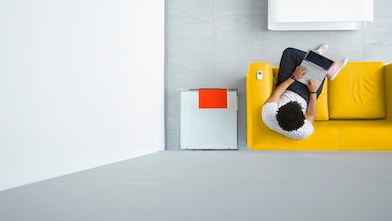 Person relaxing on a sofa in the office