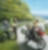 two riders, one driving on the road, one filling up motorcycle with fuel