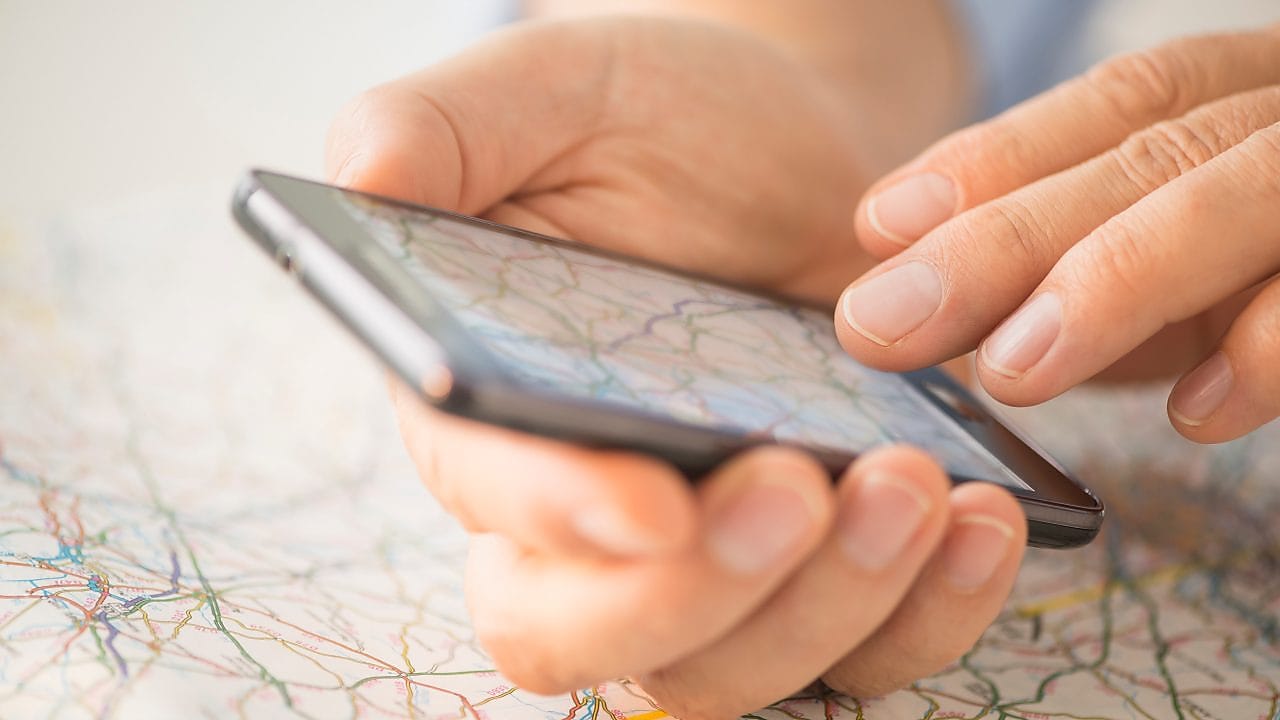 Man navigating on map in a smart phone