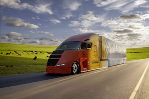 side view of the Starship 3.0 truck driving by a field of cows.