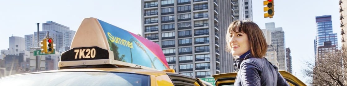 woman getting into a yellow taxi