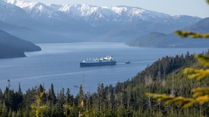 LNG tanker in a bay in Canada, with snowy mountains in the background