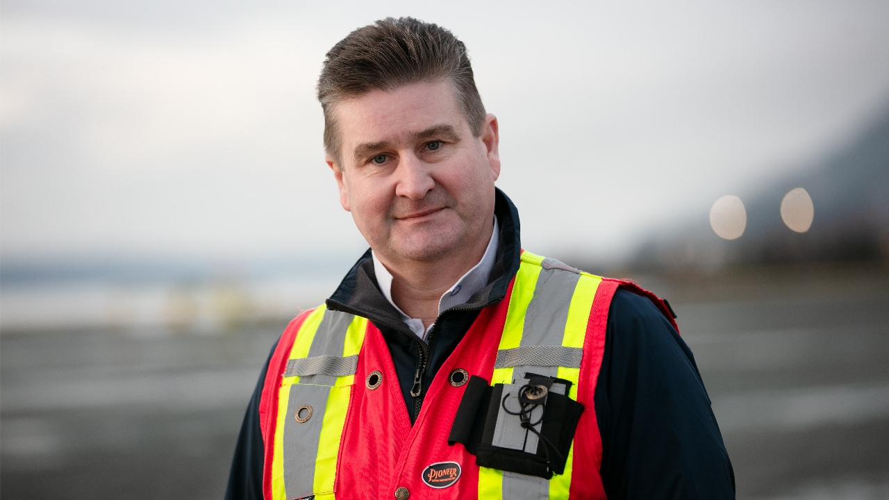 Gerard Bowers, Governance Manager at Train 7, wearing a red and yellow reflector jacket and looking at the camera.