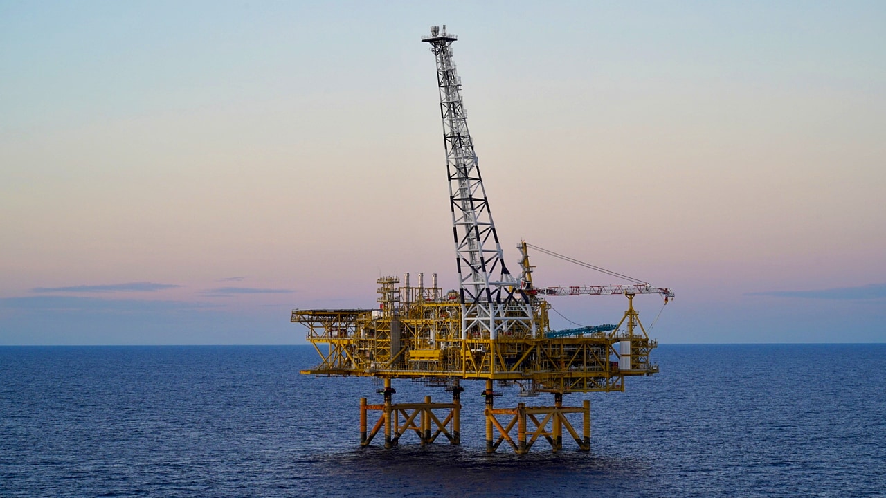 The Crux offshore platform stands in open water, with a tall central tower rising above the facility.​