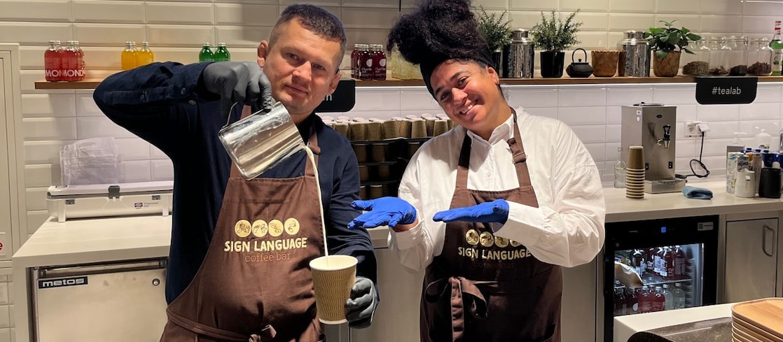 Najla Curiel and Yuri Hanenko, two deaf baristas at Shell’s sign language café in The Hague.