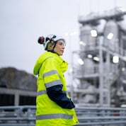 Heidi Fjellvang, Northern Lights’ System Engineering Manager, with the tanks that store the CO₂ at the terminal.