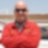 Eddie Childs, Turnaround Manager at Pearl GTL – the biggest GTL plant in the world – wearing a red overall and black sunglasses.